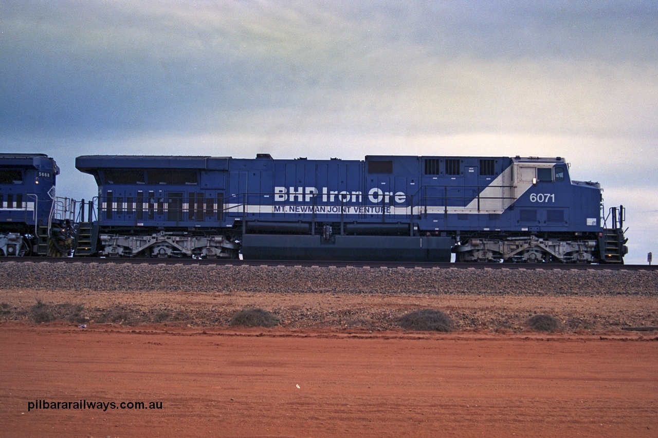 254-20
Bing Siding, an empty train awaits departure time behind 6071 an General Electric built AC6000 model with serial number 51063. The locomotive has not yet been named. Side view. September 2001.
Keywords: 6071;GE;AC6000;51063;