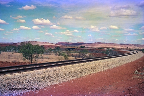 255-23
Western Creek, looking south alongside the Robe River interconnecting line with the Western Creek bridge, in the far background the pole line is the Hamersley Iron Dampier to Tom Price line. Geodata [url=https://goo.gl/maps/XKJRKgjAEhKLAzgu5]location here[/url]. May 2002.
