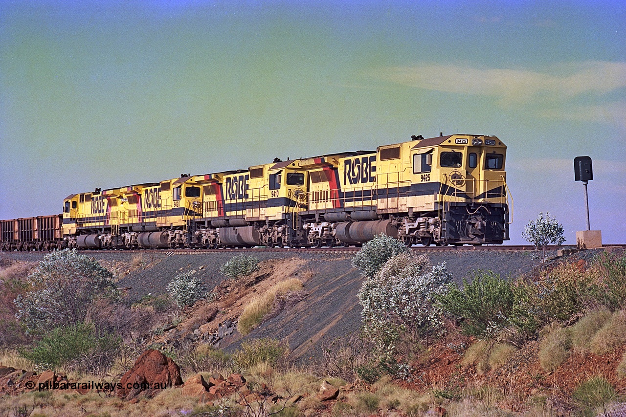 256-01
Maitland Siding on the Cape Lambert to Deepdale railway has a late afternoon empty train with the quad CM40-8M working of 9425, 9410, 9420 and 9414 in the siding waiting for a cross with an opposing loaded train. At the time of this image Siding 3 or Murray Camp was unable to cross ore trains so Siding One - Harding or Siding Two - Maitland were used. May 2002.
Keywords: 9425;Goninan;GE;CM40-8M;6266-8/89-85;rebuild;AE-Goodwin;ALCo;M636;G-6041-4;