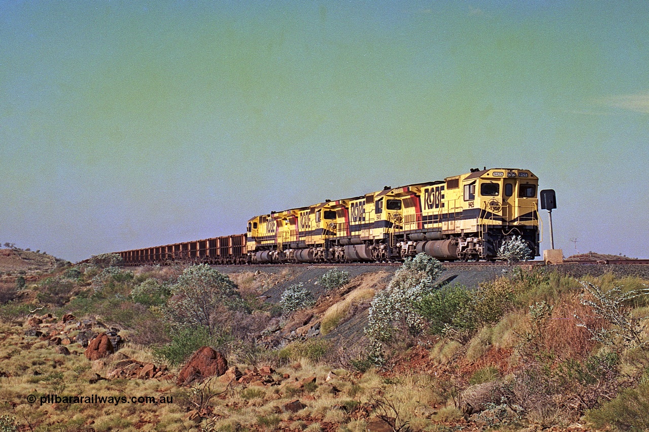 256-04
Maitland Siding on the Cape Lambert to Deepdale railway has a late afternoon empty train with the quad CM40-8M working of 9425, 9410, 9420 and 9414 in the siding waiting for a cross with an opposing loaded train. At the time of this image Siding 3 or Murray Camp was unable to cross ore trains so Siding One - Harding or Siding Two - Maitland were used. May 2002.
Keywords: 9425;Goninan;GE;CM40-8M;6266-8/89-85;rebuild;AE-Goodwin;ALCo;M636;G-6041-4;