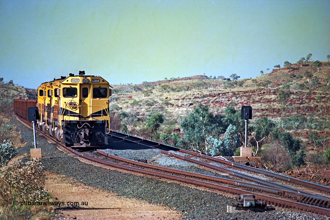 256-09
Maitland Siding on the Cape Lambert to Deepdale railway has a late afternoon empty train with the quad CM40-8M working of 9425, 9410, 9420 and 9414 in the siding waiting for a cross with an opposing loaded train. At the time of this image Siding 3 or Murray Camp was unable to cross ore trains so Siding One - Harding or Siding Two - Maitland were used. May 2002.
Keywords: 9425;Goninan;GE;CM40-8M;6266-8/89-85;rebuild;AE-Goodwin;ALCo;M636;G-6041-4;