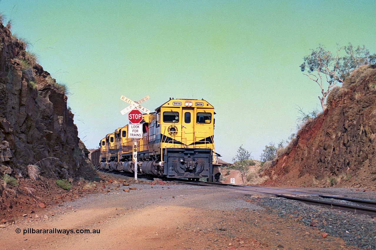 256-32
At the 89.6 km grade crossing the loaded train behind the quad CM40-8M working of 9414, 9420, 9410 and 9425 rolls across the crossing and heads down the 1.26 percent grade. May 2002.
Keywords: 9414;Goninan;GE;CM40-8M;8206-11/91-124;rebuild;AE-Goodwin;ALCo;M636;G6060-5;