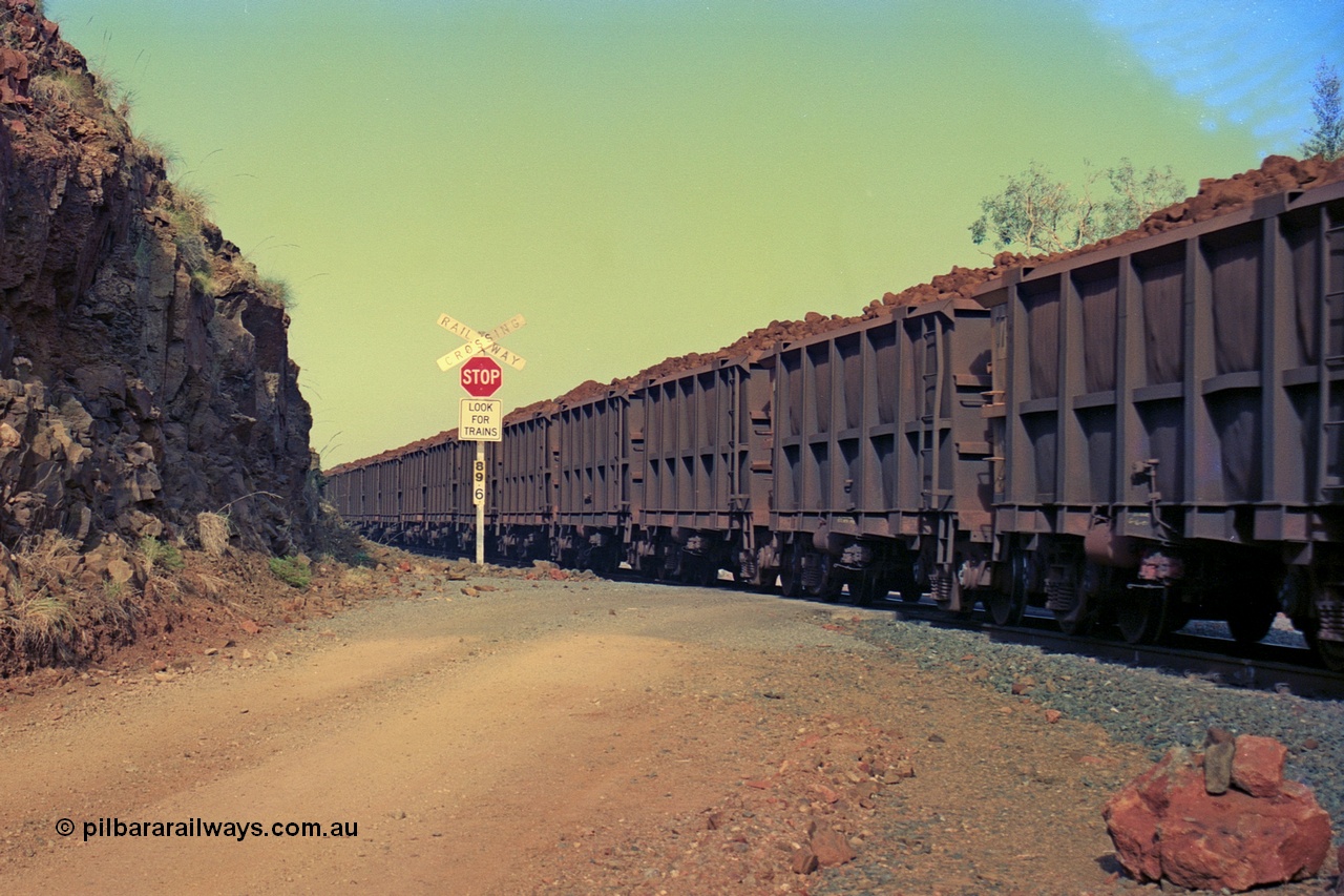 256-37
At the 89.6 km grade crossing the loaded Robe River waggons across the crossing. May 2002.
