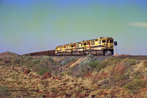 256-03
Maitland Siding on the Cape Lambert to Deepdale railway has a late afternoon empty train with the quad CM40-8M working of 9425, 9410, 9420 and 9414 in the siding waiting for a cross with an opposing loaded train. At the time of this image Siding 3 or Murray Camp was unable to cross ore trains so Siding One - Harding or Siding Two - Maitland were used. May 2002.
Keywords: 9425;Goninan;GE;CM40-8M;6266-8/89-85;rebuild;AE-Goodwin;ALCo;M636;G-6041-4;