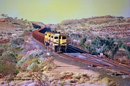 256-12
Maitland Siding on the Cape Lambert to Deepdale railway has a late afternoon empty train with the quad CM40-8M working of 9425, 9410, 9420 and 9414 in the siding waiting for a cross with an opposing loaded train. At the time of this image Siding 3 or Murray Camp was unable to cross ore trains so Siding One - Harding or Siding Two - Maitland were used. May 2002.
Keywords: 9425;Goninan;GE;CM40-8M;6266-8/89-85;rebuild;AE-Goodwin;ALCo;M636;G-6041-4;