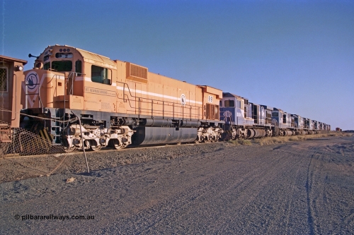 257-16
Flash Butt yard, line up of retired power, the final Comeng NSW built ALCo M636 unit 5499 serial number C6096-4 in Mount Newman Mining livery and then the eight withdrawn Goninan ALCo to GE rebuild C36-7M units 5506, 5510, 5512, 5511, 5513, 5507, 5509 and 5508. Late 2001.
Keywords: 5499;Comeng-NSW;MLW-ALCo;M636;C6096-4;