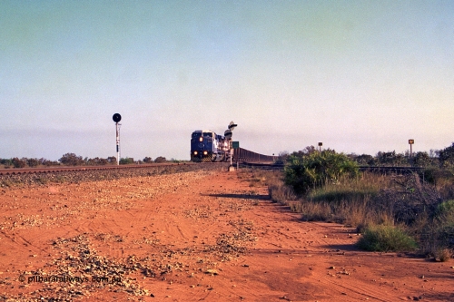 257-30
Goldsworthy Junction an empty train thunders through the junction behind 6000 horsepower behemoth 6072 'Hesta' serial number 51064 and built by General Electric in Erie USA in 1999 and a new built CM39-8 unit 5632 'Poseidon' by Goninan with serial number 5831-11 / 88-081. Late 2001.
Keywords: 6072;GE;AC6000;51064;