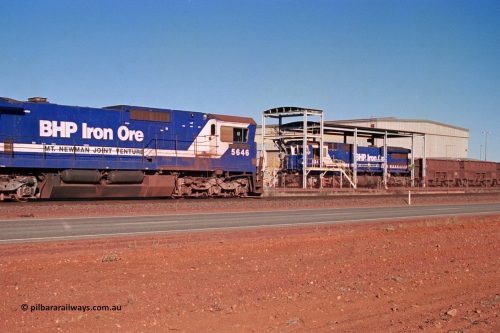 275-02
Boodarie, BHP Iron Ore's CM40-8 locomotive 5646 'White Springs' arrives along the mainline as it is bound for the unloading hopper at Finucane Island as it passes rebuilt CM40-8M unit 5645 in the prep bay. The fuel tank and bogies shows that 5646 was a new build, serial number 8244-11 / 92-135 and built by Goninan in November 1992, the same build date as 5645. August 10, 2003.
Keywords: 5646;Goninan;GE;CM40-8;8244-11/92-135;