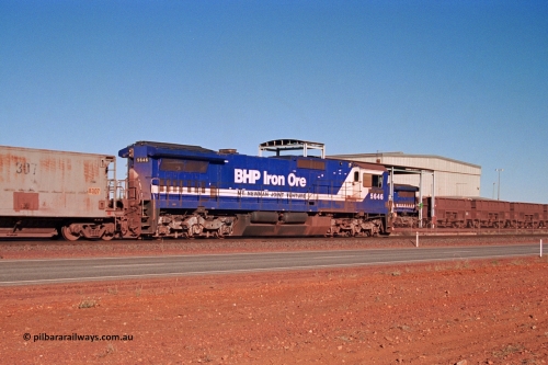275-03
Boodarie, BHP Iron Ore's CM40-8 locomotive 5646 'White Springs' arrives along the mainline as it is bound for the unloading hopper at Finucane Island as it passes rebuilt CM40-8M unit 5645 in the prep bay. The fuel tank and bogies shows that 5646 was a new build, serial number 8244-11 / 92-135 and built by Goninan in November 1992, the same build date as 5645. The waggons behind 5646 are former Phelp Dodge hoppers built by Gunderson in the USA and purchased by BHP in 1992. August 10, 2003.
Keywords: 5646;Goninan;GE;CM40-8;8244-11/92-135;