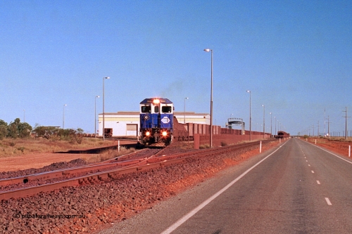 275-09
Boodarie, BHP Iron Ore's 5645 'Sherlock' departs the service road on its way to Yarrie with an empty. The loaded is running down the mainline towards Finucane Island. This scene has changed immensely since August 10, 2003.
Keywords: 5645;Goninan;GE;CM40-8M;8281-11/92-134;rebuild;AE-Goodwin;ALCo;M636C;5475;G6047-7;