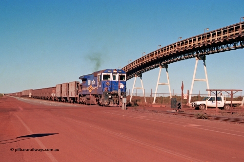 275-18
Finucane Island, BHP Iron Ore's CM40-8 locomotive 5646 'White Springs' arrives at the island across the -0.8 km grade crossing and the No. 6 switch where the balloon loops rejoins the mainline. The elevated conveyor is for the HBI plant. August 10, 2003.
Keywords: 5646;Goninan;GE;CM40-8;8244-11/92-135;