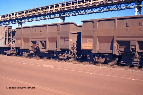275-26
Boodarie, BHP Iron Ore's Goninan Golynx bottom discharge waggon 8415 with serial number 950088-345 built in November 2001 coupled behind 8400, this was the prototype originally done by the ore car shop, with subsequent orders for similar bottom discharge waggons build by Goninan. 8415 is one such example and notice the subtle differences, the scalloped end, angle iron on the waggon top edge and the better clearance of the discharge doors. August 10, 2003.
Keywords: 8415;Goninan;Golynx;950088-345;BHP/GML-ore-waggon;