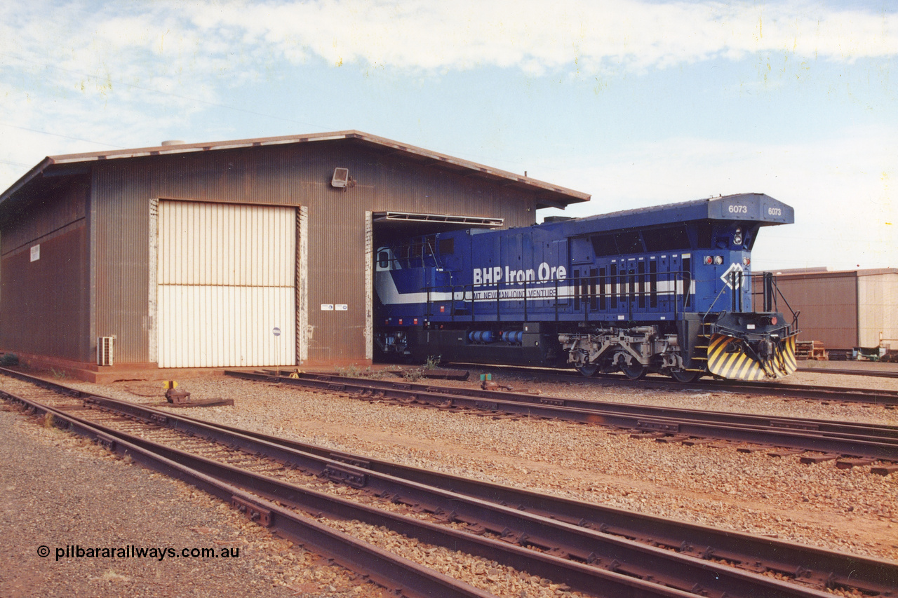 283-01
Nelson Point, BHP wheel lathe sees BHP's big GE AC6000 unit 6073 'Fortescue' serial number 51065 on shed having wheel attention to the leading bogie. May 2002.
Keywords: 6073;GE;AC6000;51065;