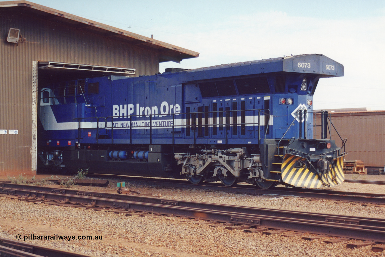 283-02
Nelson Point, BHP wheel lathe sees BHP's big GE AC6000 unit 6073 'Fortescue' serial number 51065 on shed having wheel attention to the leading bogie. May 2002.
Keywords: 6073;GE;AC6000;51065;