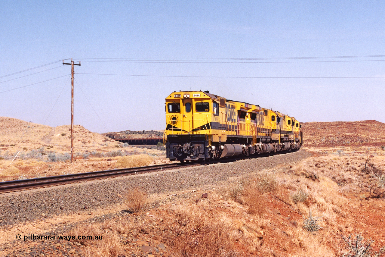 283-15
At the 45.4 km grade crossing on the Robe River line, loaded train easers around the curve behind the standard quad Goninan CM40-8M units led by 9414 serial number 8206-11 / 91-124 and rebuilt from the final of the original five ALCo units ordered from construction. 22nd of May 2002.
Keywords: 9414;Goninan;GE;CM40-8M;8206-11/91-124;rebuild;AE-Goodwin;ALCo;M636;G6060-5;