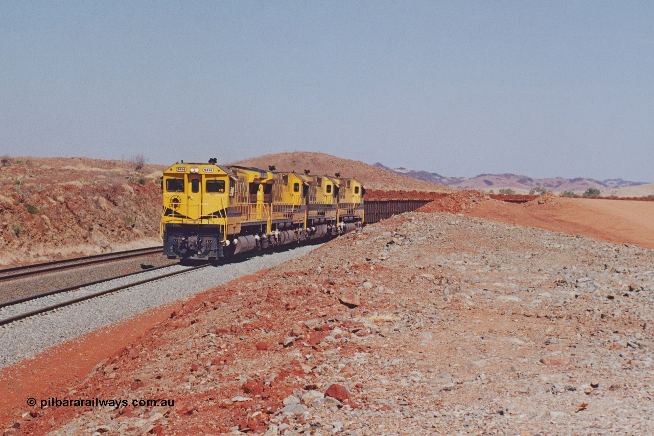 283-18
Harding Siding, quad Robe River CM40-8M units 9414, 9420, 9410 and 9425 lead 202 loaded ore waggons at Siding 1 (Harding). The siding has recently been renamed Harding and extended at the north end to accommodate the new West Angelas trains of up to 240 waggons. Wednesday 22nd May 2002.
Keywords: 9414;Goninan;GE;CM40-8M;8206-11/91-124;rebuild;AE-Goodwin;ALCo;M636;G6060-5;