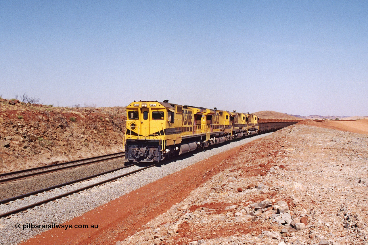 283-20
Harding Siding, quad Robe River CM40-8M units 9414, 9420, 9410 and 9425 lead 202 loaded ore waggons at Siding 1 (Harding). The siding has recently been renamed Harding and extended at the north end to accommodate the new West Angelas trains of up to 240 waggons. Wednesday 22nd May 2002.
Keywords: 9414;Goninan;GE;CM40-8M;8206-11/91-124;rebuild;AE-Goodwin;ALCo;M636;G6060-5;