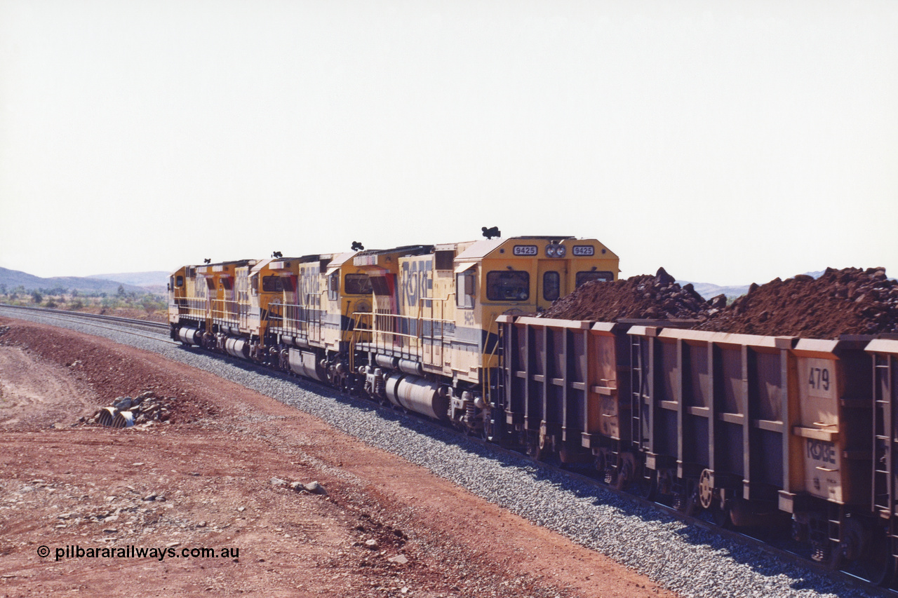 283-28
Harding Siding, quad Robe River CM40-8M units 9414, 9420, 9410 and 9425 lead their 202 loaded ore waggons through the passing track at Siding 1 (Harding) following recent extension of the loop and renaming to Harding. The extension is at the north end to accommodate the new West Angelas trains of up to 240 waggons. Wednesday 22nd May 2002.
Keywords: 9425;Goninan;GE;CM40-8M;6266-8/89-85;rebuild;AE-Goodwin;ALCo;M636;G-6041-4;