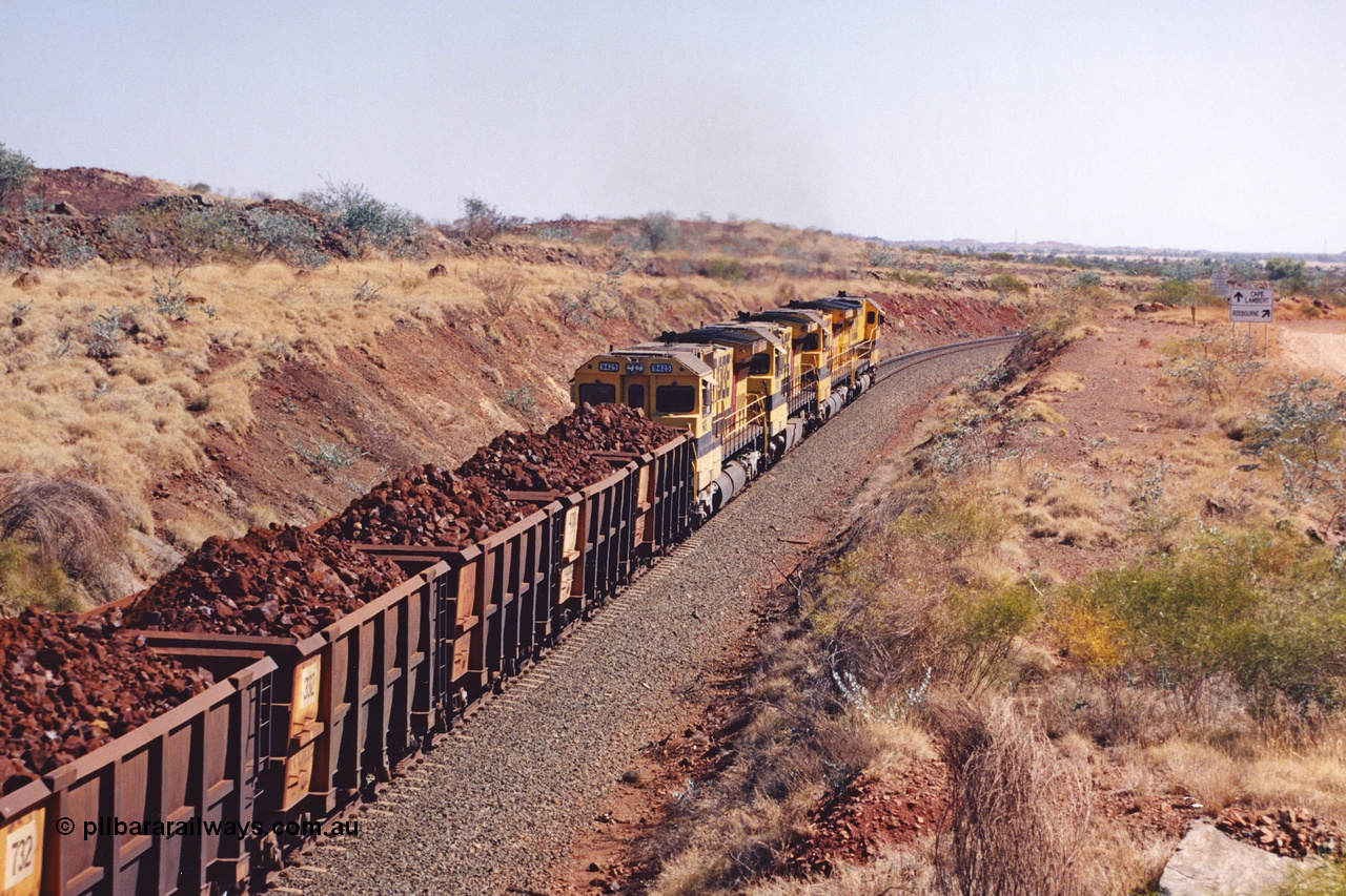 283-37
Near Woodbrook, quad Robe River CM40-8M units 9414, 9420, 9410 and 9425 lead their 202 loaded ore waggons around the curve away from the 37.5 km pipe bridge and are now Cape Lambert bound. Wednesday 22nd May 2002.
