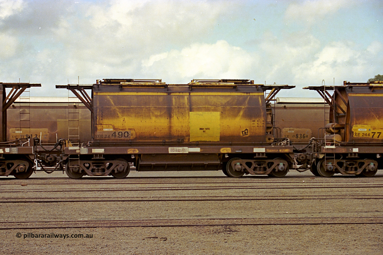 284-07
Narngulu yard, XEB type hopper waggon XEB 24490 built by Westrail Midland Workshops in 1976 as part of a batch of forty-one XE type waggons for ilmenite cartage, and fitted with vacuum bypass pipes and recoded in ~1983 to XEB, seen here labelled for zircon traffic. November 8, 2004.
Keywords: XEB-type;;XEB24490'Westrail-Midland-WS;