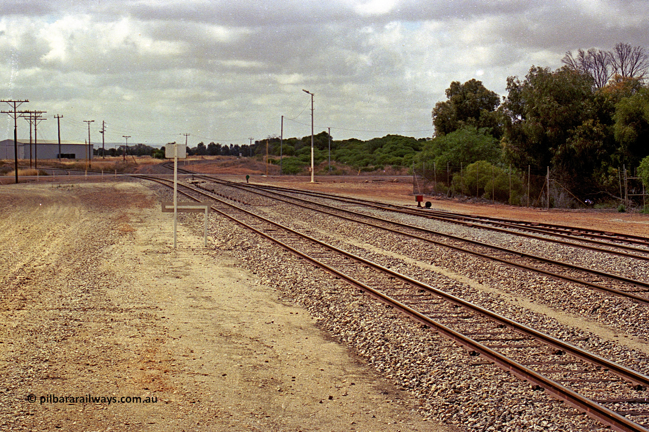 284-13
Narngulu yard looking south east across the grade crossing for Rudds Gully Road with the line to Mullewa curving away to the left and the line to Dongara curving away to the right. November 9, 2004.
