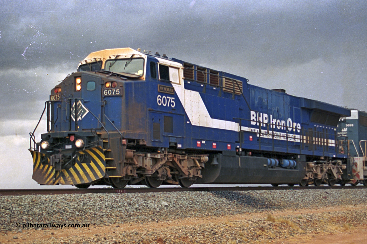 284-36
Bing Siding, 18 km south of Nelson Point and BHP's GE built AC6000 unit 6075 'Newman', serial number 51097, holds the mainline with a loaded train and EMD SD40R unit 3095 as second unit. Late 2004.
Keywords: 6075;GE;AC6000;51067;