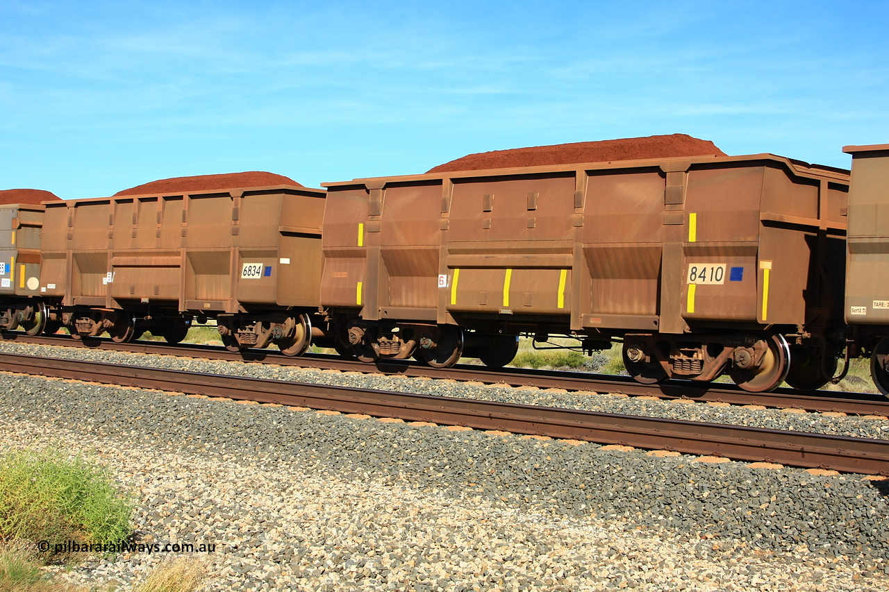 110620 1965r
Walla Siding, comparison between two BHP ore waggons loaded with Yandi fines of the Golynx design type, 8410 was built in November 2001 for bottom discharge on the Goldsworthy system with serial number 950088-340, while 6834 was built in 2008. The burn or weld marks are still visible on 8410 from when it was in GML service, now converted for rotary service, noticed the filled in end and the angle section along the top edge for support. 20th of June 2011.
Keywords: 8410;6834;Goninan-WA;Golynx;950088-340;GML-waggon;BHP-ore-waggon;