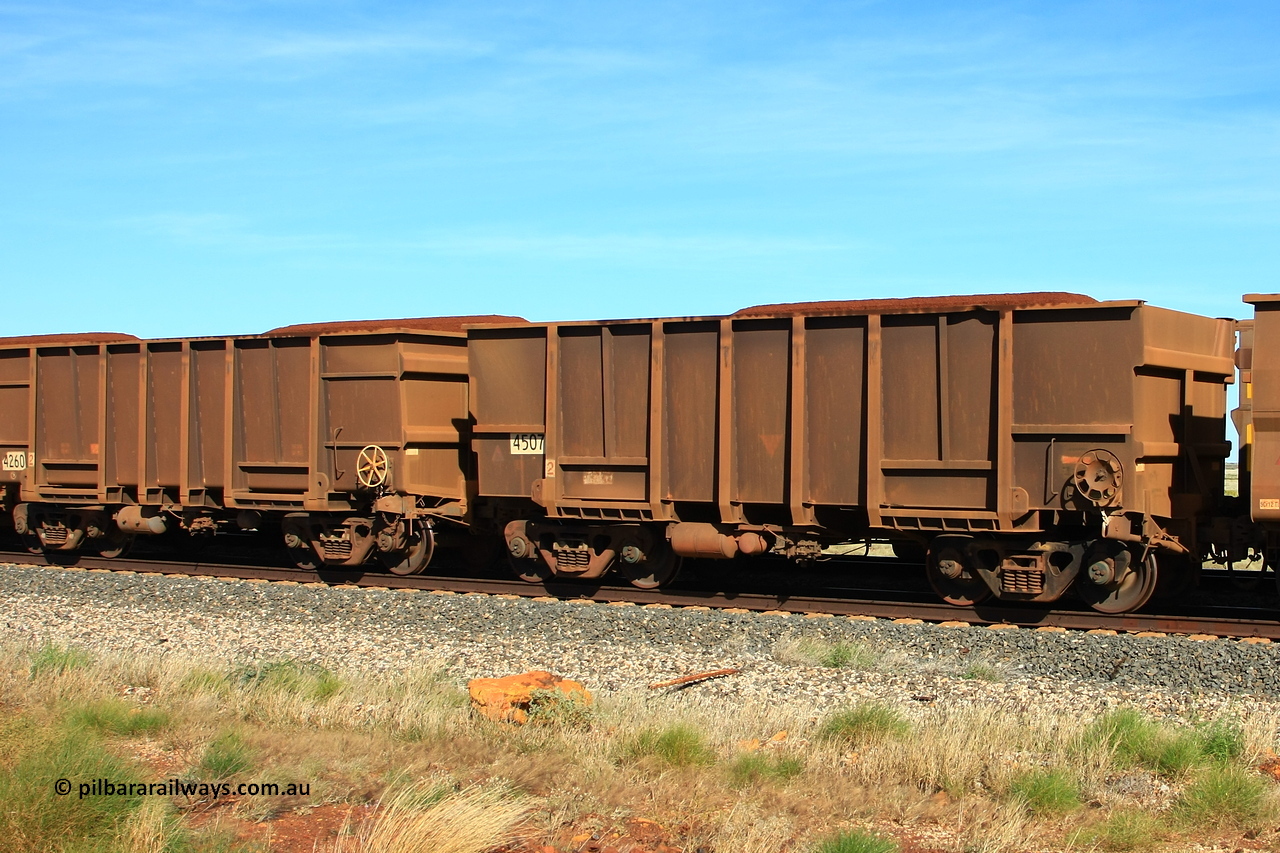 110620 2014r
Walla Siding, comparison between two empty BHP ore waggons with the tapered floor design. 4507 was built by Transfield WA in in 1976 in an order for eighteen waggons, while 4260 is a Goninan WA build from an order of one hundred and twenty-six waggons using 3CR12 stainless steel in an effort to eliminate internal painting and reducing wear on the waggon body, these were designated HC7081. 20th of June 2011.
Keywords: 4507;Transfield-WA;4260;Goninan-WA;HC7081;BHP-ore-waggon;
