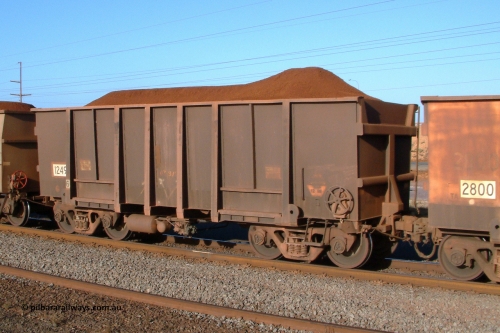 1249 Comeng 041001 165100
Redbank, loaded BHP Iron Ore waggon 1249, a Comeng WA original build from 1971, looks to have been partly resheeted and the Yandi loadout must has had a glitch hence the odd loading profile. October 1, 2004.
Keywords: 1249;Comeng-WA;BHP-ore-waggon;