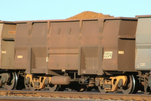 2204 Goninan 040802 080715
Nelson Point, loaded BHP ore waggon 2204, a Goninan replacement Golynx body style from 3Cr12 stainless steel from a 2001-02 build of 345 replacement bodies, with yellow bogies. August 2, 2004.
Keywords: 2204;Goninan-WA;BHP-ore-waggon;