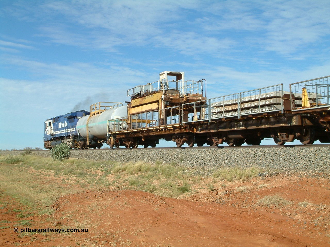 040502 085548
Mooka Siding, trailing view of the 'Pony' heading south, 50 ton waggon 6703, one of three 'special' waggons converted from Magor USA built ore waggons, loaded with concrete sleepers is closet to camera. 
Keywords: Magor-USA;BHP-pony-waggon;