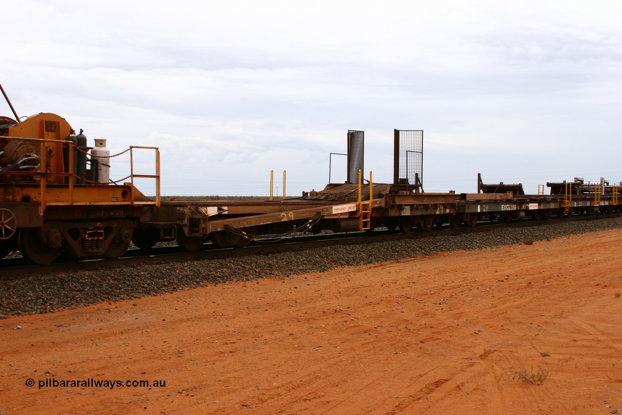 050522 2739
Goldsworthy Junction, rail recovery and transport train, 1st lead off waggon 6011, built by Scotts of Ipswich Qld in September 1970, the mesh guarding is for the winch cable. The chute arrangement for the discharging and recovery of rail is visible.
Keywords: Scotts-Qld;BHP-rail-train;