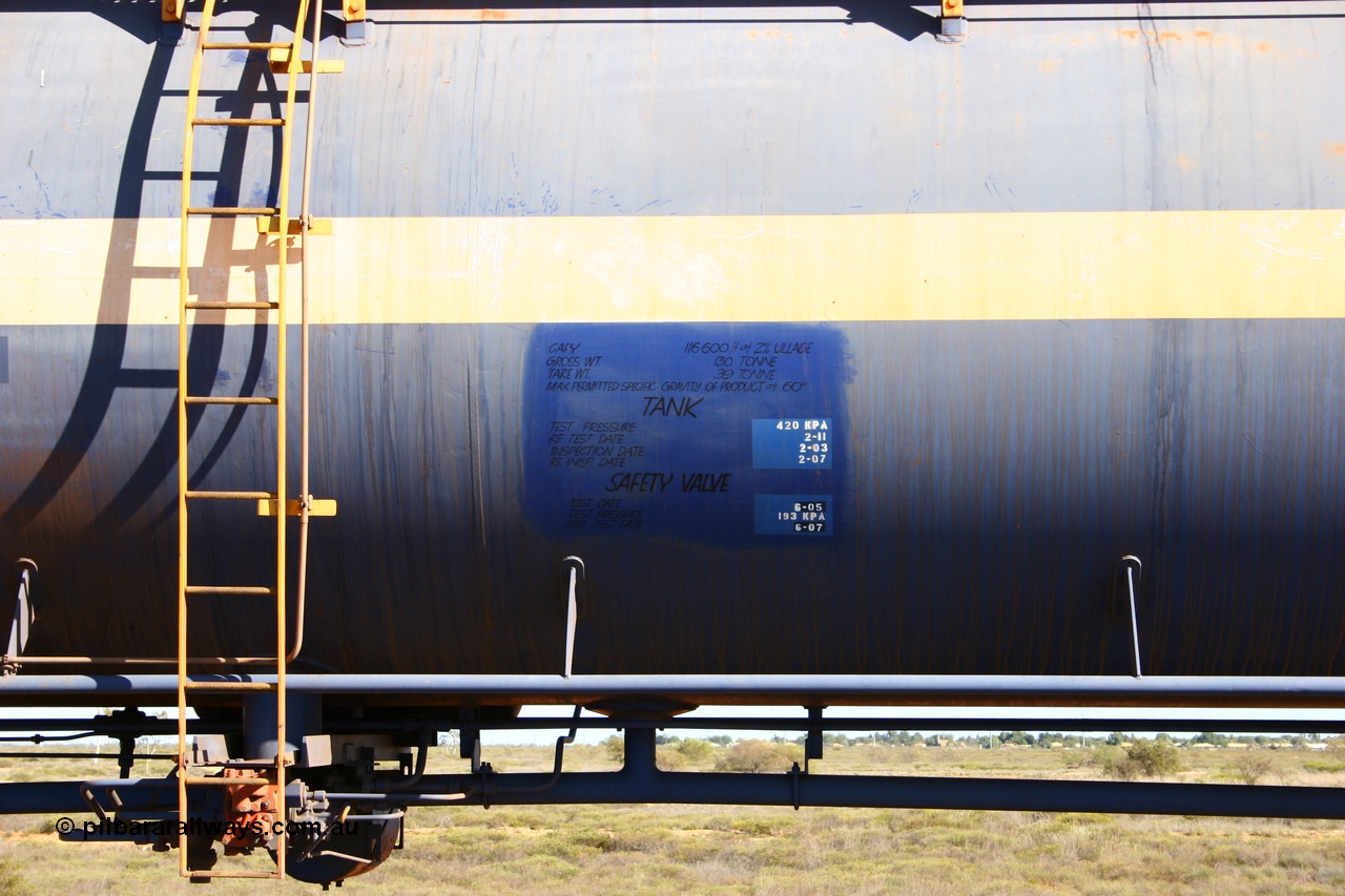 050704 3972
Bing Siding, empty 116 kL Comeng NSW built tank waggon 0012 from 1972, one of three such tank waggons, view of data placard, ladder and valving, on the rear of a loaded ore train.
Keywords: Comeng-NSW;BHP-tank-waggon;