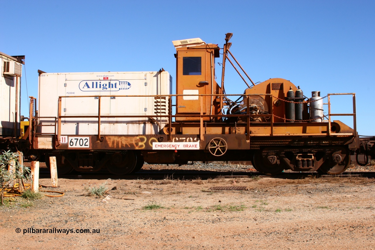 050801 4763
Flash Butt yard, rail recovery and transport train, flat waggon 6702, heavily cut down and modified Magor USA ore waggon by Mt Newman Mining workshops, converted to a 50 tonne waggon and designated the winch waggon with generator set to power the winch and the crib car.
Keywords: Magor-USA;Mt-Newman-Mining-WS;BHP-rail-train;