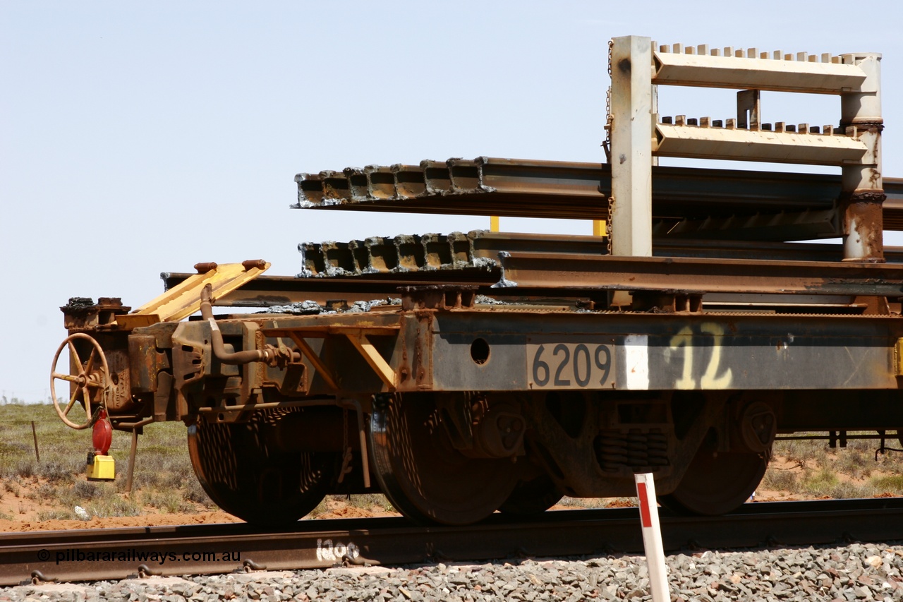 051001 5686
Boodarie, the Steel Train or rail recovery and transport train, hand brake end of waggon #12, 6209, a Comeng WA built flat waggon from January 1977 under order no. 07-M-282 RY.
Keywords: Comeng-WA;BHP-rail-train;