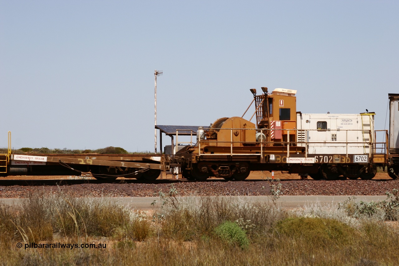 051001 5739
Boodarie, the Steel Train or rail recovery and transport train, flat waggon #30, 6702, heavily cut down and modified Magor USA ore waggon by Mt Newman Mining workshops, converted to a 50 tonne waggon and designated the winch waggon with generator set to power the winch and the crib car.
Keywords: Magor-USA;Mt-Newman-Mining-WS;BHP-rail-train;