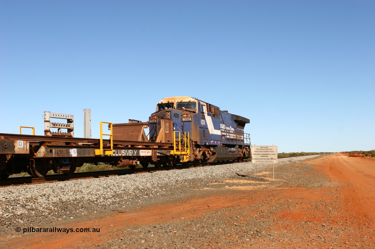 060721 7335
Bing Siding, rail recovery and transport train flat waggon rear lead off waggon 6203, built by Comeng WA in January 1977. The AC6000 loco on the rear has a pulled coupler and is being towed to Hedland.
Keywords: Comeng-WA;BHP-rail-train;