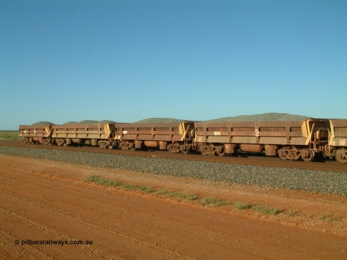 8702 Difco USA 040408 170040
Bing Siding, Difco Ohio USA built side dump waggons, three short and one long all loaded with fines. In 1966 five short side dump waggons were originally built for Goldsworthy Mining, here we see no. 2, 3 and 1 on the rear and Mt Newman Mining long side dump waggon 701.
Keywords: Difco-Ohio-USA;GML;BHP-ballast-waggon;