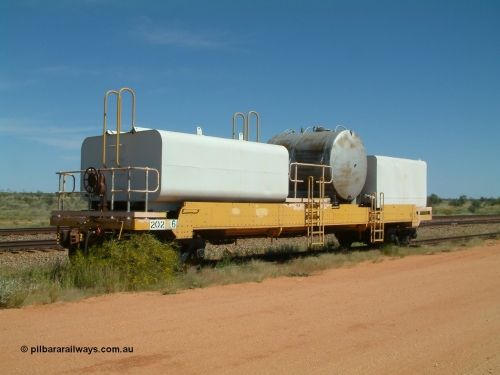0202 USA 040419 102034
Abydos back track, riveted flat waggon 202 with three water tanks fitted, 3/4 view from handbrake end, originally part of the 'camp train', modified by Mt Newman Mining railway workshops.
Keywords: BHP-flat-waggon;