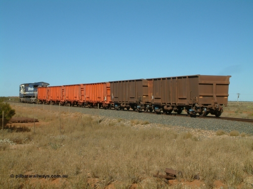 040806 091122
Goldsworthy Junction, trailing view of the weighbridge test train with the four orange weighbridge test waggons and one of the two Comeng built ore waggons to provide braking, 5666 is the power.
