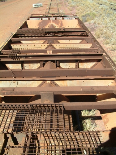 0206 Mt Newman Mining Workshops 040806 102052
Flash Butt yard, heavily stripped down riveted waggon 206, possible original ballast waggon, number 206 was originally a waggon in the 'Camp Train' and appears to have USA origin, view of the removed deck showing chutes.
