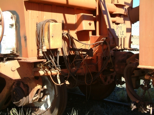 2703 Mt Newman Mining Workshops 040806 102536
Flash Butt yard, view of the end of test waggon 2703 showing the collection of cables and the Do Not Uncouple sign.
Keywords: Comeng-WA;BHP-Comeng-Ore-Waggon;BHP-Service-Waggon;