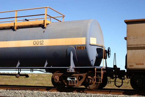 0012 Comeng NSW 050704 3971
Bing Siding, empty 116 kL Comeng NSW built tank waggon 0012 from 1972, one of three such tank waggons, view of handbrake detail, on the rear of a loaded ore train.
Keywords: Comeng-NSW;BHP-tank-waggon;