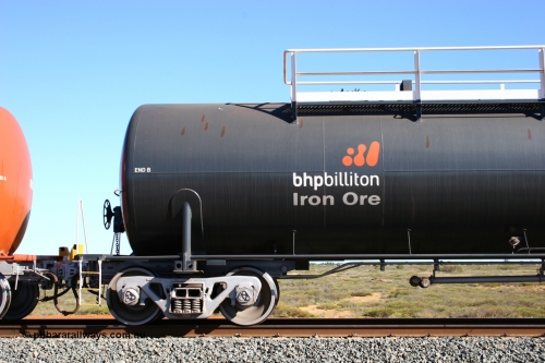 0018 Comeng WA 050704 3980
Bing Siding, empty 116 kL Comeng WA built tank waggon 0018 from 1974-5, one of six such tank waggons, detail of the B end and bogie, wearing the BHP Billiton Earth livery.
Keywords: Comeng-WA;BHP-tank-waggon;