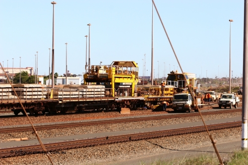 050724 4237
Nelson Point yard, flat waggons in service on the Pony re-laying train as transport waggons for sleepers, with a gantry car delivering concrete sleepers to replace the removed steel sleepers. The left waggon is an ex Goldsworthy Mining flat waggon with a Scotts of Ipswich built flat waggon with the gantry car on it, built in 1970 for then Mt Newman Mining Company.
Keywords: Scotts-Qld;BHP-pony-waggon;