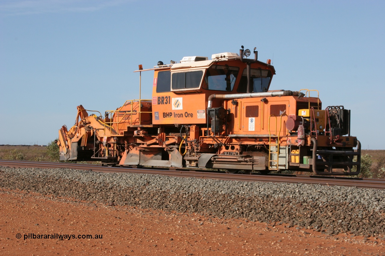 050411 0600
Goldsworthy Junction, BHP track machine ballast regulator BR 31 a Plasser Australia SSP 110SW model with serial 401 comes off the former Goldsworthy line with the Newman mainline in the foreground. 11th April 2005.
Keywords: BR31;Plasser-Australia;SSP-110SW;401;track-machine;