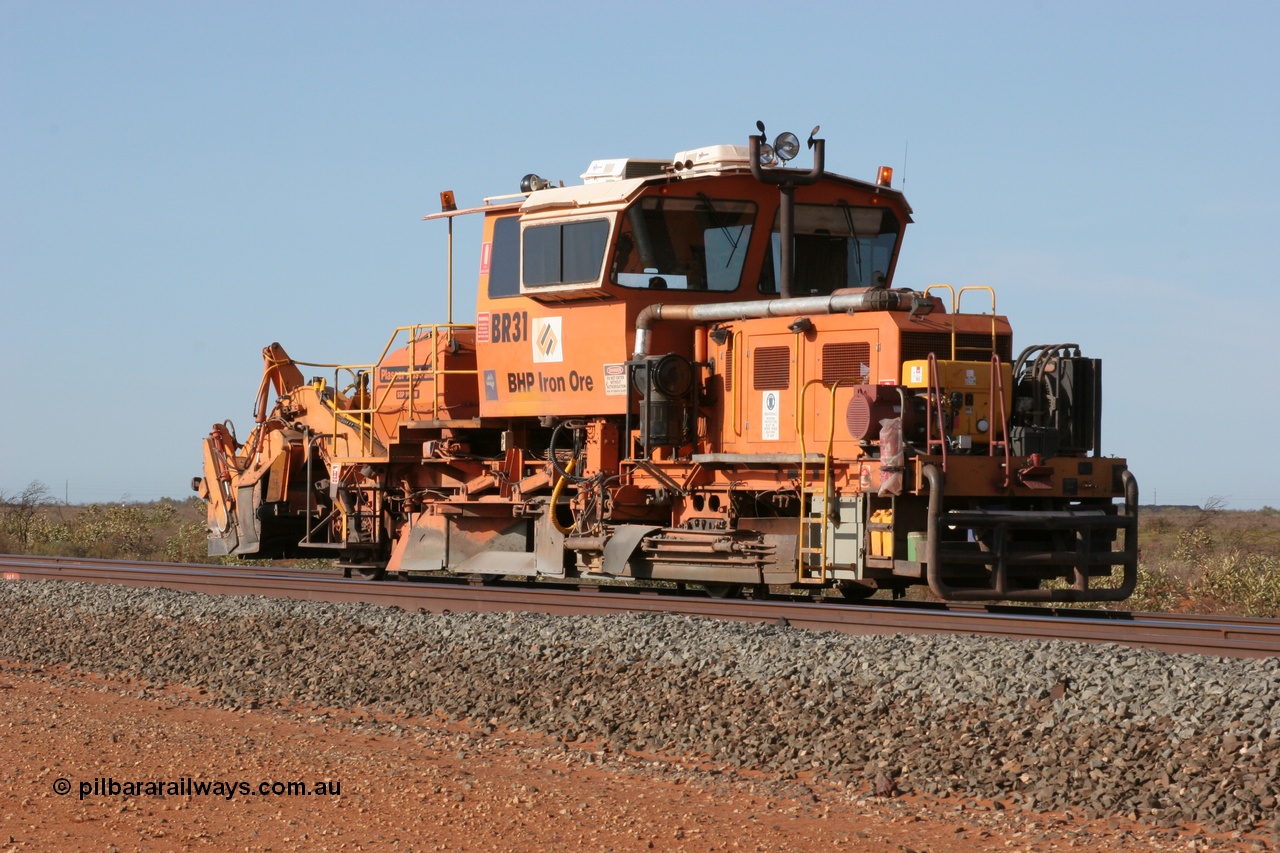050411 0601
Goldsworthy Junction, BHP track machine ballast regulator BR 31 a Plasser Australia SSP 110SW model with serial 401 comes off the former Goldsworthy line with the Newman mainline in the foreground. 11th April 2005.
Keywords: BR31;Plasser-Australia;SSP-110SW;401;track-machine;