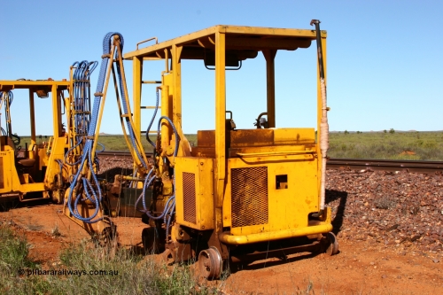 050625 3819
Node 2 at the 38 km on the GML or former Goldsworthy mainline, a Barclay Mowlem sleeper inserter track machine off clear of the running lines. 25th June 2005.
Keywords: track-machine;