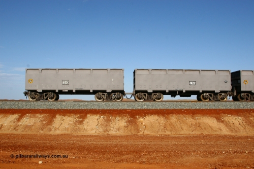 01395-02396 080116 1365
Chapman Siding at the 69 km on FMG's under construction line to Cloud Break mine, new waggons stabled in the passing track awaiting service, built by China Southern or CSR at their Zhuzhou Rolling Stock Works in China in 2007, here slave waggon 1395 and master waggon 2396 sit in the arvo sunlight. The yellow circle indicates the rotary coupler end and the tare weight of the slave waggon at 22.6 tonnes, while the master weighs 22.9 tonnes as it hosts the brake control equipment. 16th January 2008. 
Keywords: 1395-2396;CSR-Zhuzhou-Rolling-Stock-Works-China;FMG-ore-waggon;