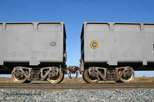 02396 080116 1375
Chapman Siding, view of FMG's CSR Zhuzhou Rolling Stock Works built waggons showing the 'F' type Interlock fixed and rotary couplers between master waggon 2396 and slave waggon 1187. Note the difference in the tare weights, 2396 with the fixed coupler is the master waggon, while 1187 is the slave waggon with the rotary coupler. The yellow circle also denotes the rotary coupler end. 16th January 2008.
Keywords: 2396;CSR-Zhuzhou-Rolling-Stock-Works-China;FMG-ore-waggon;